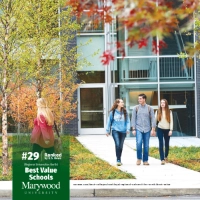 three students walk toward foreground from learning commons